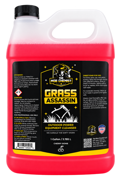 A 1 gallon plastic jug of M8B Chemist Grass Assassin Outdoor Power Equipment Cleanser, filled with bright pink liquid, featuring a black cap and a detailed black label with yellow and white graphics.